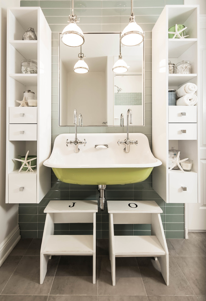 Photo of a beach style kids bathroom in New York with white cabinets, green tile, glass tile and a trough sink.