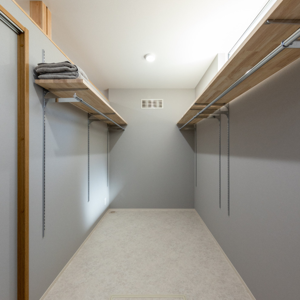 Design ideas for a storage and wardrobe in Other with grey floor and wallpaper.