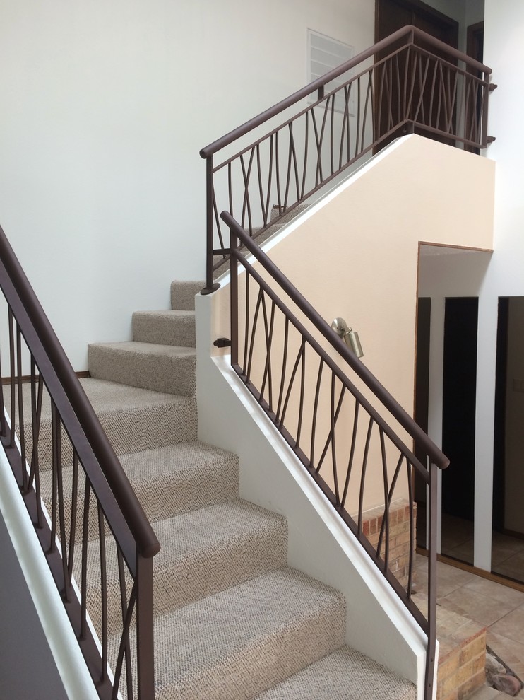 Staircase - modern metal l-shaped metal railing staircase idea in Albuquerque with carpeted risers