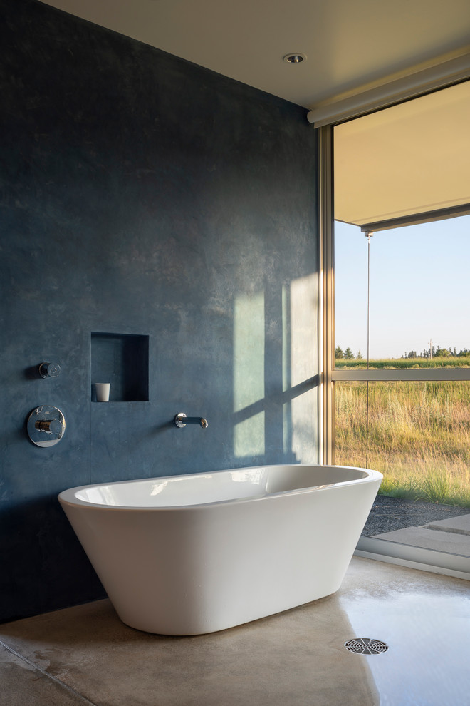 This is an example of a mid-sized contemporary master wet room bathroom in Other with a freestanding tub, grey walls, concrete floors, grey floor and an open shower.
