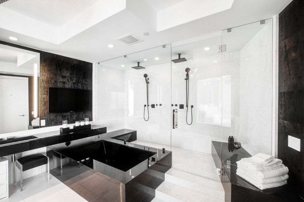 Design ideas for a contemporary master bathroom in Miami with a hot tub, a double shower, white tile, black walls, an integrated sink, white floor, a hinged shower door and black benchtops.