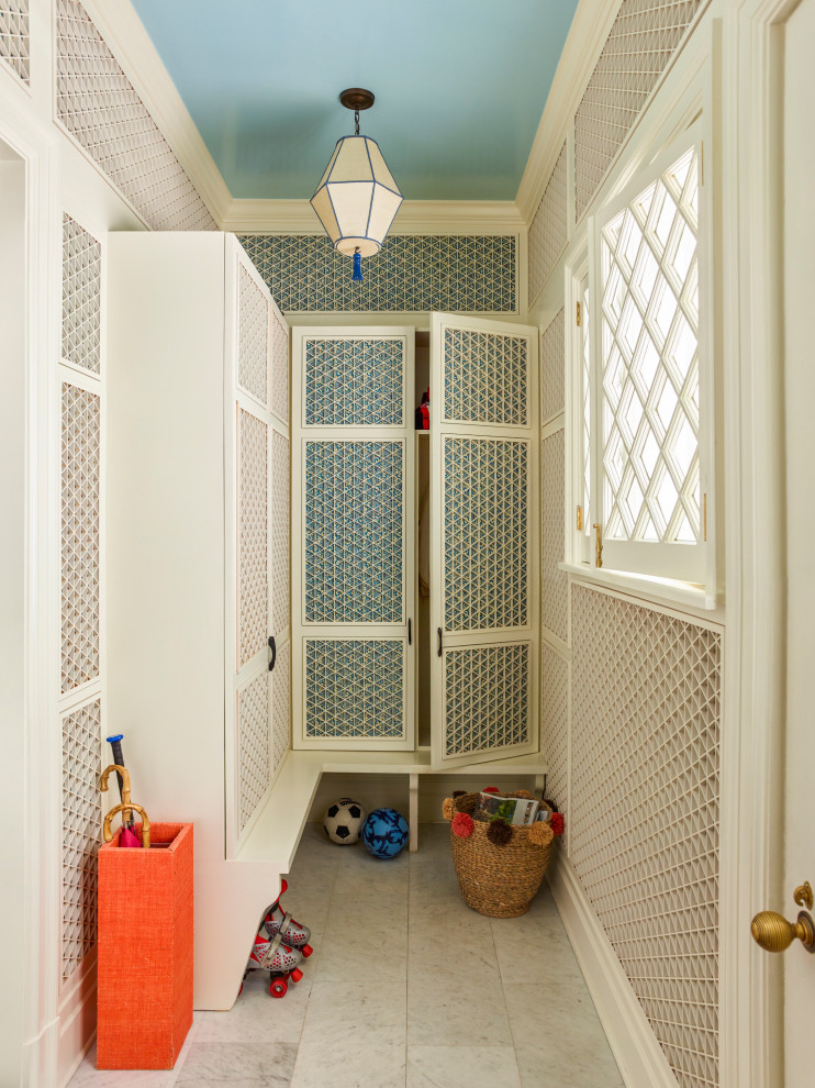 Larchmont Victorian - A bright, beautiful renovation of a happy 1880s Victorian house. There was no real place for a mudroom off the kitchen; this one is off the front door! It's a little alcove that we optimized for 4 kids. Each one has a locker, theres a tiny perch for putting on shoes. The wall treatment is a Japanese trellis backed by chiyogami paper. All cabinetry and lighting designed by us.