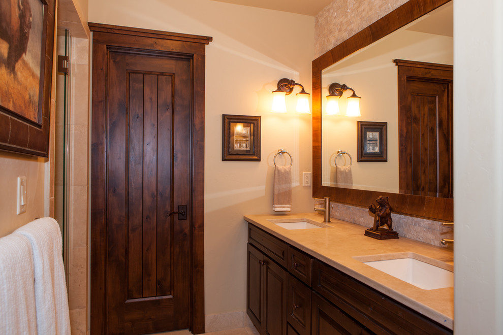 Photo of a mid-sized transitional master bathroom in Denver with shaker cabinets, dark wood cabinets, a drop-in tub, an alcove shower, beige tile, ceramic tile, beige walls, ceramic floors, an undermount sink and tile benchtops.