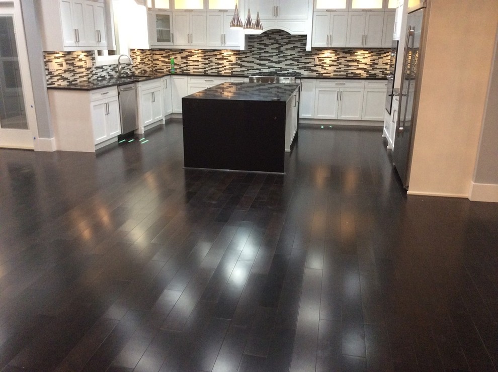 Inspiration for a large transitional u-shaped dark wood floor and brown floor open concept kitchen remodel in Orange County with an undermount sink, shaker cabinets, white cabinets, quartz countertops, multicolored backsplash, matchstick tile backsplash, stainless steel appliances and an island