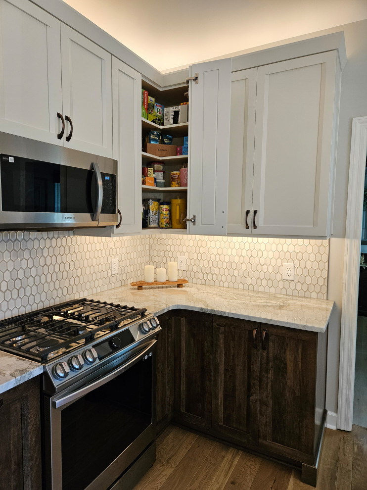 Example of a mid-sized transitional eat-in kitchen design in Nashville with shaker cabinets and quartz countertops