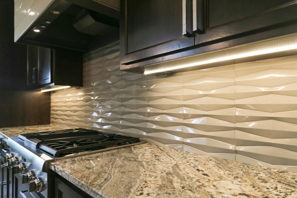 Eat-in kitchen - large transitional l-shaped light wood floor and beige floor eat-in kitchen idea with a farmhouse sink, recessed-panel cabinets, dark wood cabinets, granite countertops, gray backsplash, porcelain backsplash, stainless steel appliances, an island and multicolored countertops