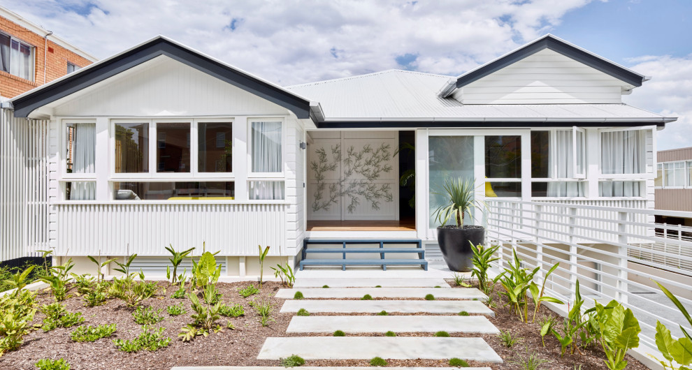 Design ideas for a mid-sized contemporary two-storey white house exterior in Brisbane with wood siding, a gable roof, a metal roof, a white roof and clapboard siding.