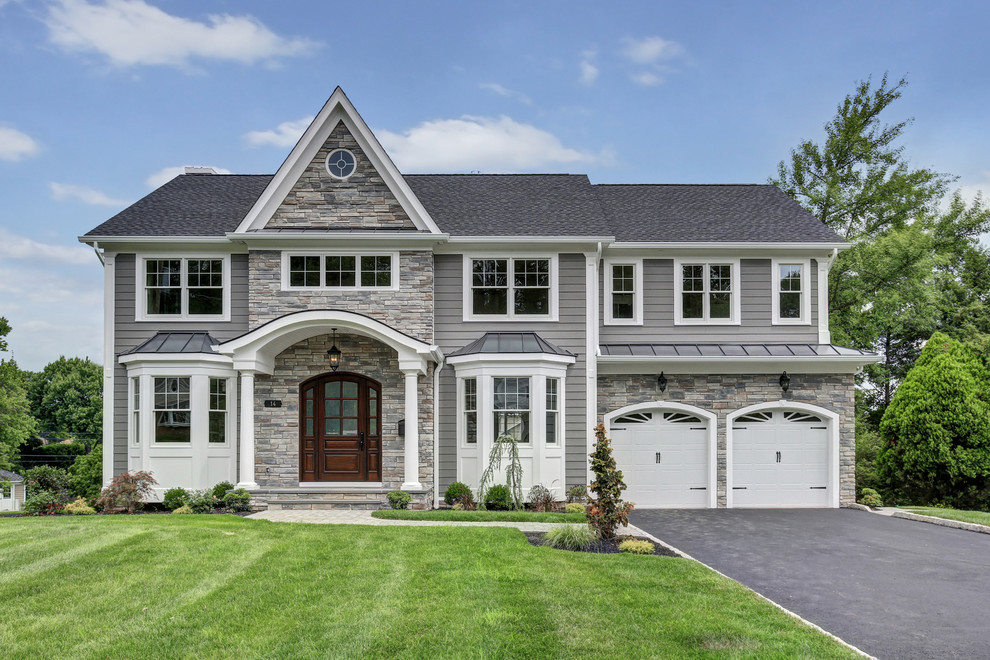 Traditional two-storey grey house exterior in New York with mixed siding and a gable roof.
