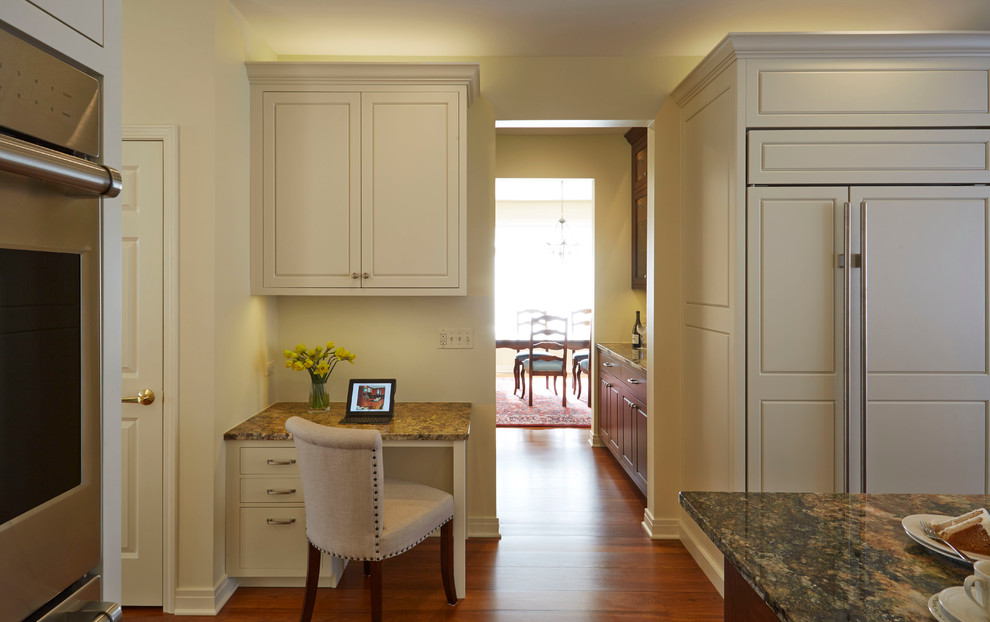 Mid-sized transitional u-shaped medium tone wood floor enclosed kitchen photo in Chicago with a single-bowl sink, raised-panel cabinets, white cabinets, granite countertops, white backsplash, glass tile backsplash, stainless steel appliances and an island