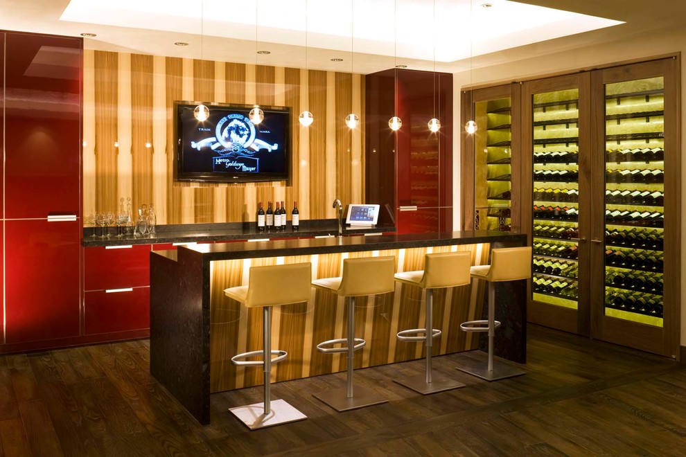Photo of a contemporary galley seated home bar in Denver with dark hardwood floors, flat-panel cabinets and red cabinets.