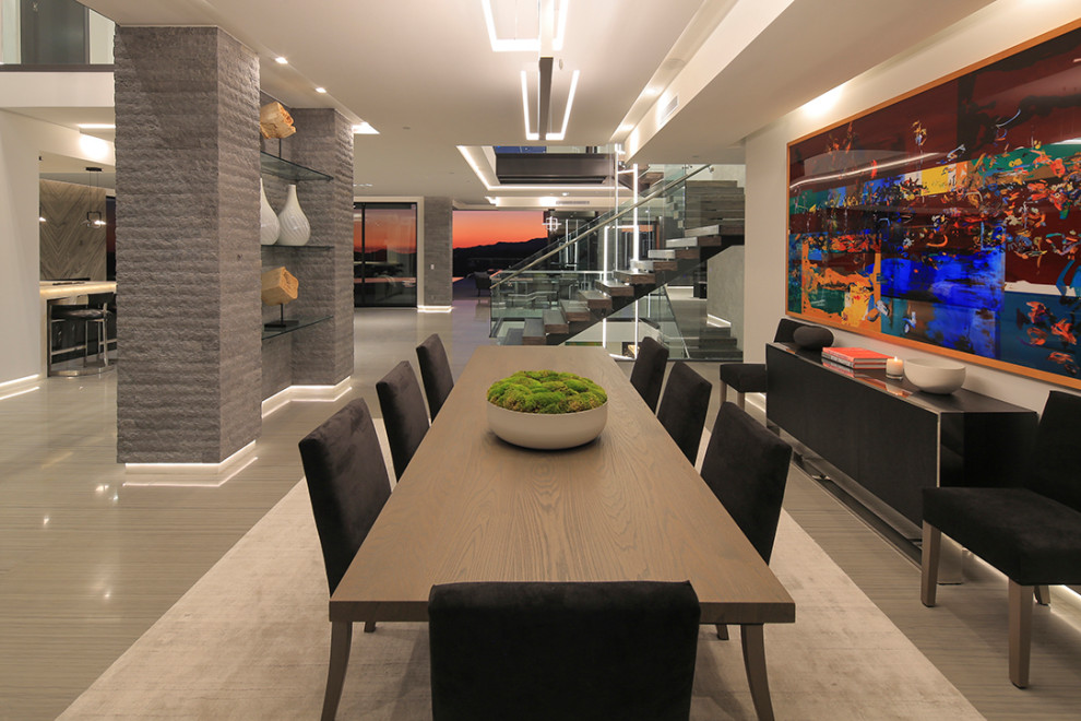 Large contemporary open plan dining in Los Angeles with limestone floors, no fireplace, grey floor and beige walls.