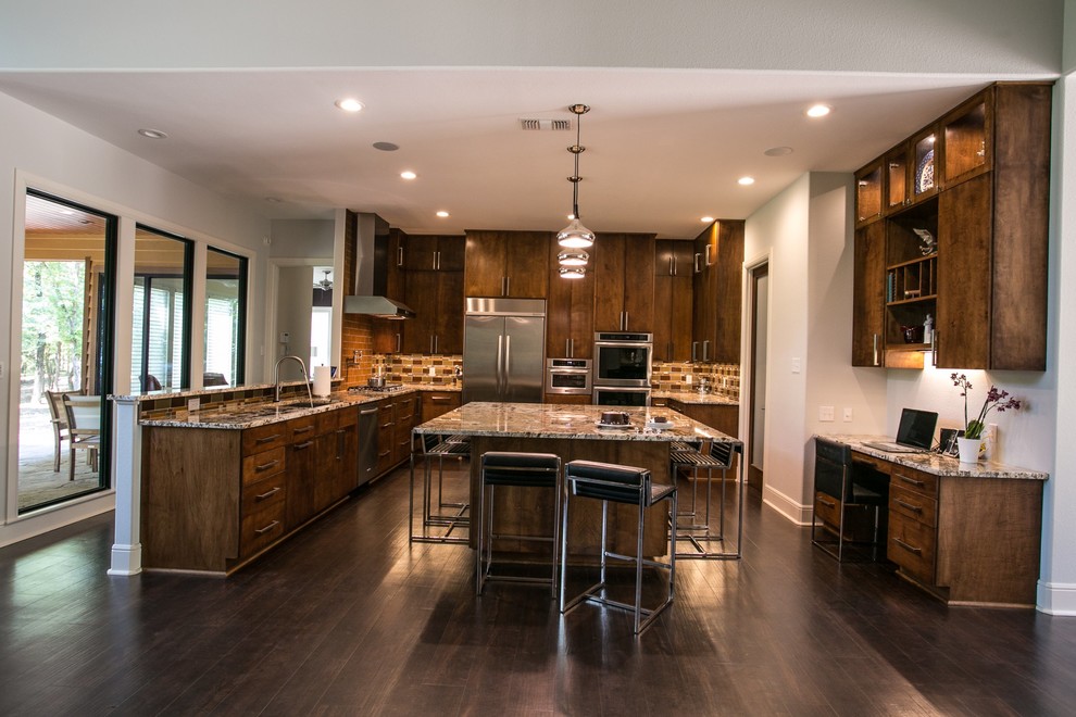 Photo of a large contemporary u-shaped eat-in kitchen in Houston with an undermount sink, flat-panel cabinets, medium wood cabinets, granite benchtops, brown splashback, glass tile splashback, stainless steel appliances, vinyl floors and with island.