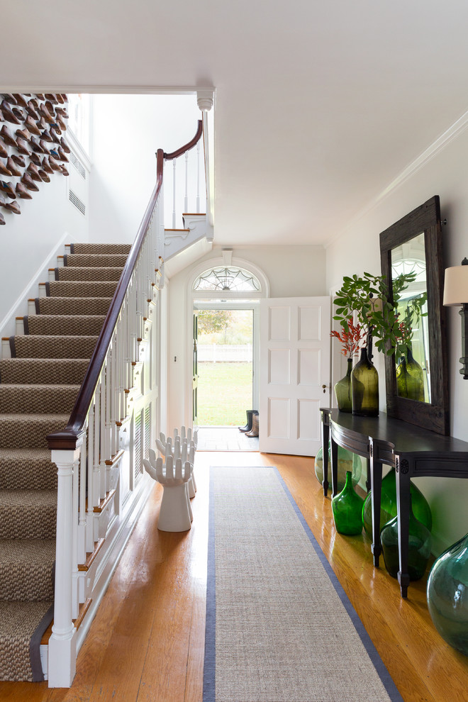 This is an example of an expansive transitional foyer in Bridgeport with white walls, medium hardwood floors, a double front door and a black front door.