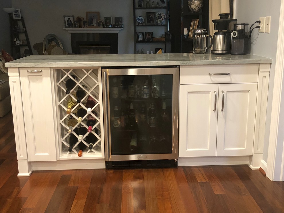 Example of a large transitional galley medium tone wood floor and brown floor eat-in kitchen design in Baltimore with a single-bowl sink, recessed-panel cabinets, white cabinets, quartzite countertops, gray backsplash, glass tile backsplash, stainless steel appliances, an island and multicolored countertops