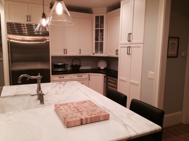 Inspiration for a transitional kitchen remodel with shaker cabinets, white cabinets and an island