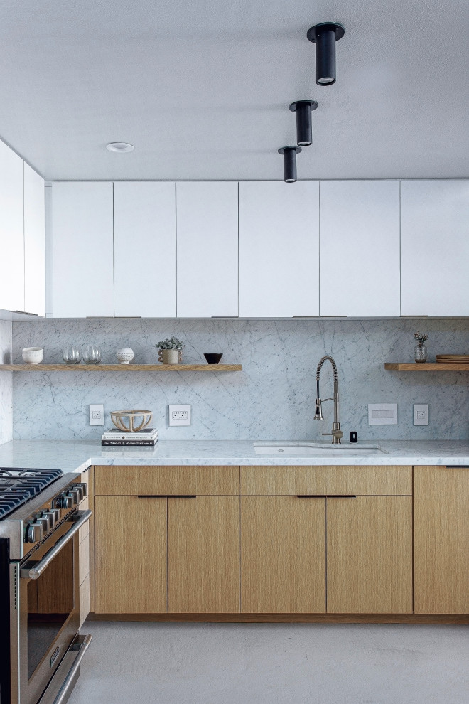 Medium sized scandinavian l-shaped kitchen/diner in San Francisco with a submerged sink, flat-panel cabinets, light wood cabinets, marble worktops, white splashback, marble splashback, white appliances, cement flooring, an island, grey floors and white worktops.