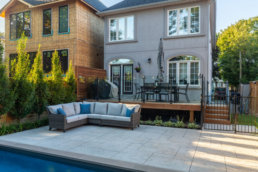 Design ideas for a small transitional backyard rectangular pool in Toronto with with a pool and stamped concrete.