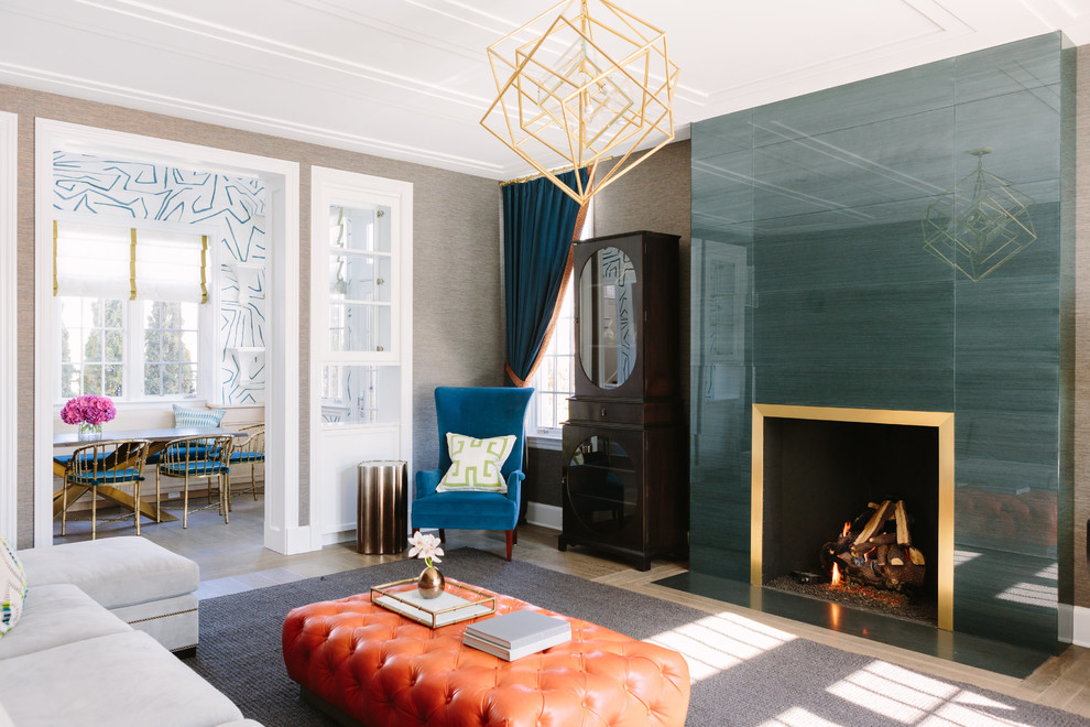 Family room - large transitional enclosed medium tone wood floor family room idea in Chicago with a standard fireplace, a metal fireplace, gray walls and no tv