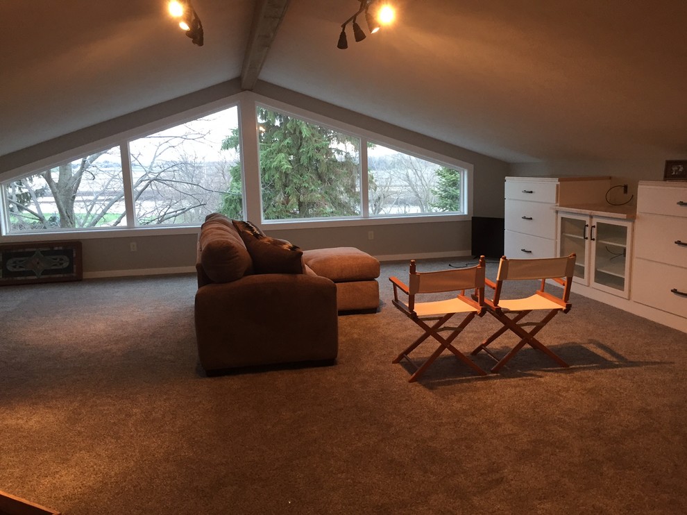 Photo of a large traditional enclosed family room in Milwaukee with grey walls, carpet, grey floor and no fireplace.