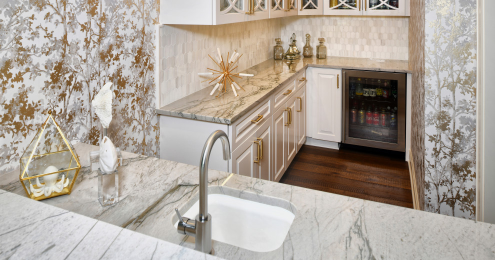 Design ideas for a mid-sized eclectic l-shaped wet bar in Houston with an undermount sink, raised-panel cabinets, white cabinets, marble benchtops, grey splashback, cement tile splashback, dark hardwood floors, brown floor and grey benchtop.