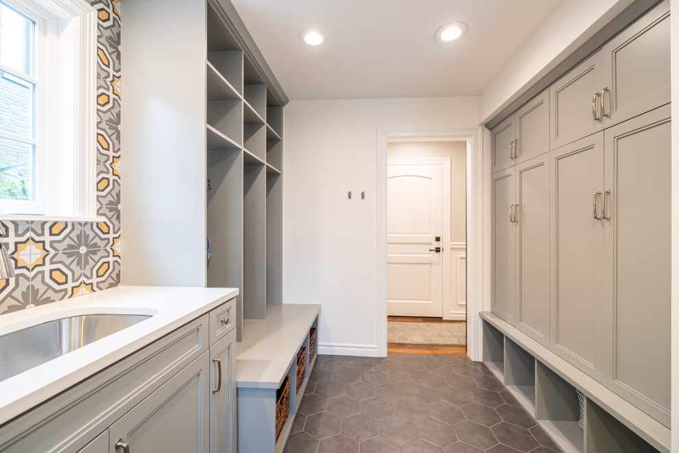 Design ideas for a large modern u-shaped utility room in Seattle with an undermount sink, flat-panel cabinets, grey cabinets, quartz benchtops, grey splashback, ceramic splashback, multi-coloured walls, ceramic floors, a side-by-side washer and dryer, grey floor and white benchtop.