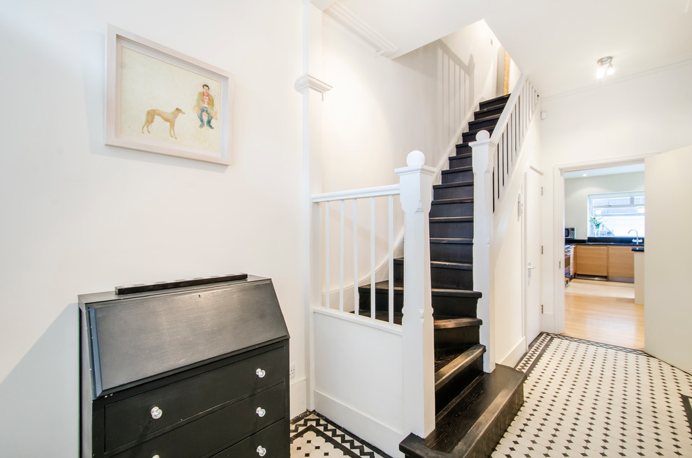 Design ideas for a mid-sized modern hallway in London with white walls and ceramic floors.