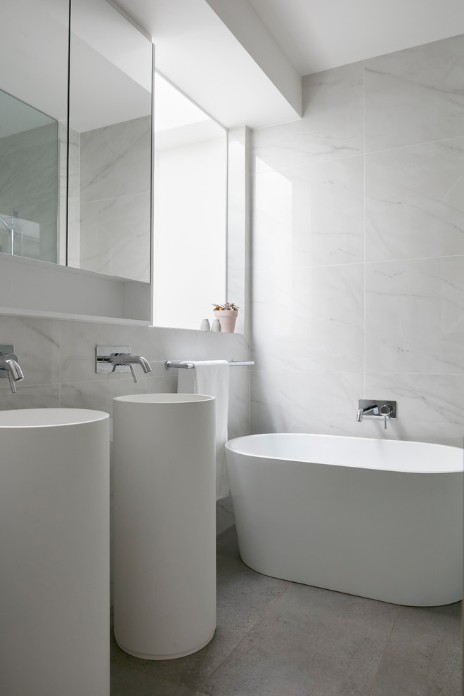 Photo of a mid-sized modern master bathroom in Melbourne with a freestanding tub, grey walls, a vessel sink, grey floor, shaker cabinets, white cabinets, white tile, marble and white benchtops.