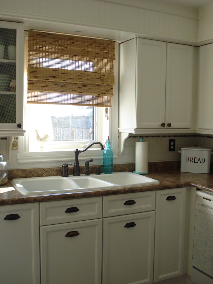 Inspiration for a traditional kitchen in Toronto with a triple-bowl sink.