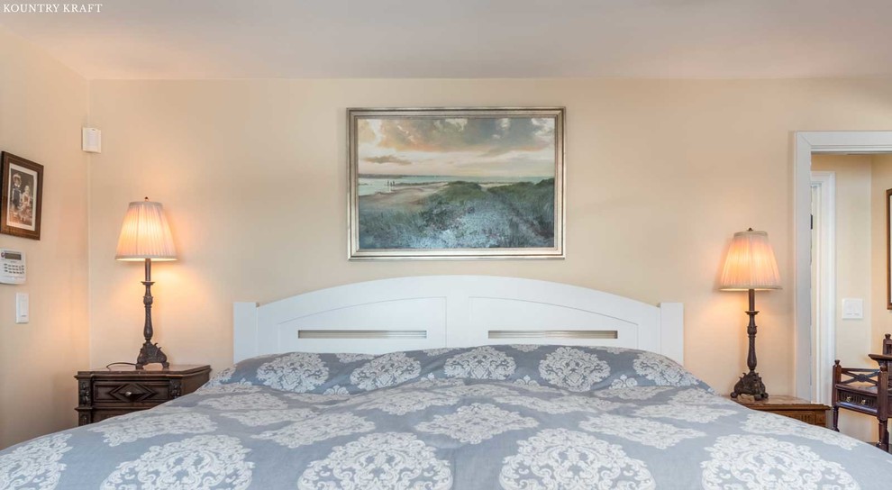 Inspiration for a mid-sized transitional master light wood floor and beige floor bedroom remodel in Boston with white walls