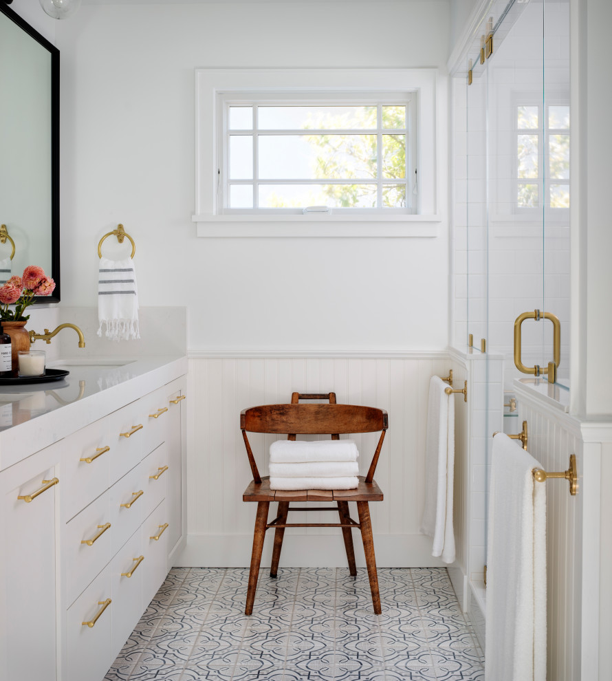 Mid-sized transitional master bathroom in San Francisco with shaker cabinets, white tile, white walls, cement tiles, an undermount sink, engineered quartz benchtops, a hinged shower door, white benchtops, a double vanity, a built-in vanity, white cabinets, an alcove shower, multi-coloured floor and decorative wall panelling.