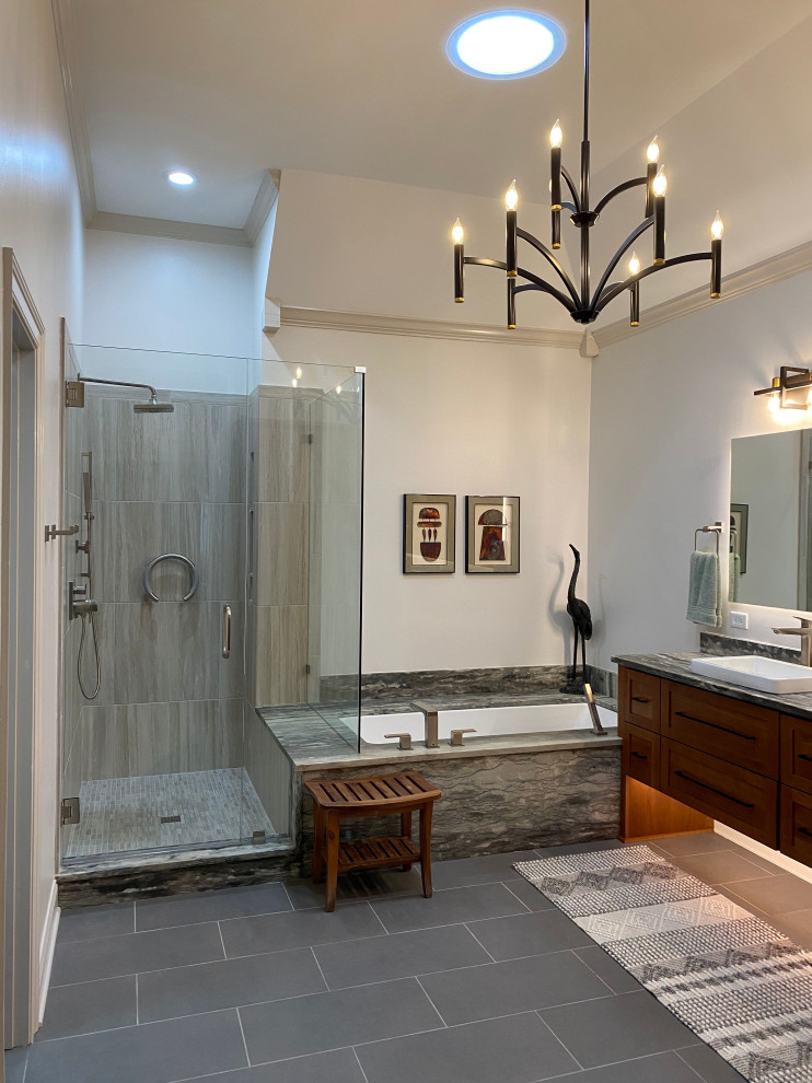 Photo of a large transitional master bathroom in Other with recessed-panel cabinets, light wood cabinets, an undermount tub, an alcove shower, a bidet, gray tile, porcelain tile, porcelain floors, a vessel sink, granite benchtops, a hinged shower door, grey benchtops, a double vanity and a floating vanity.