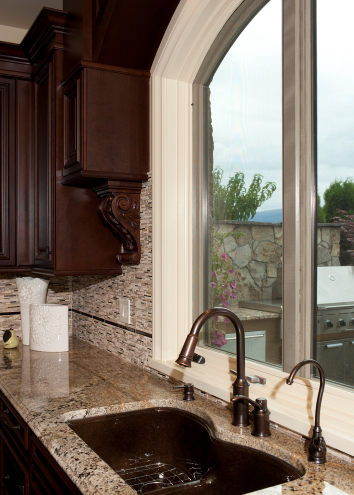 Open concept kitchen - huge rustic u-shaped porcelain tile and beige floor open concept kitchen idea with an undermount sink, raised-panel cabinets, dark wood cabinets, granite countertops, red backsplash, porcelain backsplash, stainless steel appliances and a peninsula