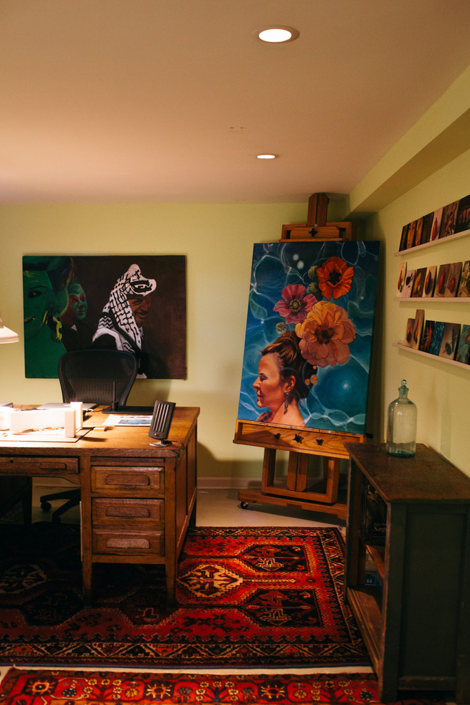 Inspiration for a mid-sized eclectic home studio in Seattle with green walls, carpet and a freestanding desk.