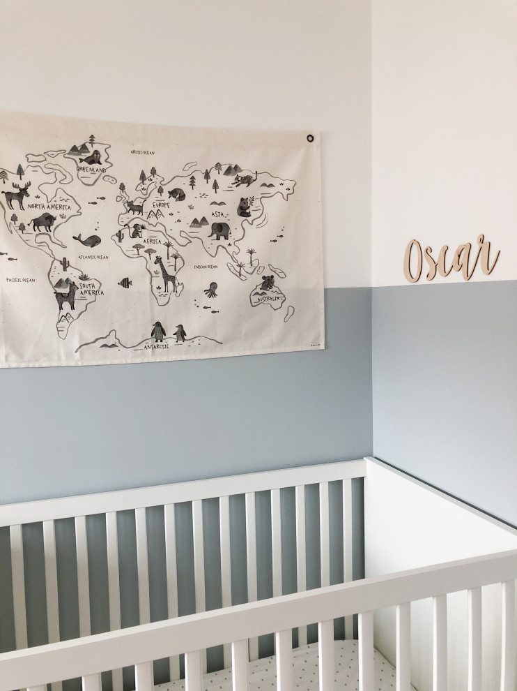 Inspiration for a small modern nursery for boys in Edinburgh with blue walls, carpet and beige floor.