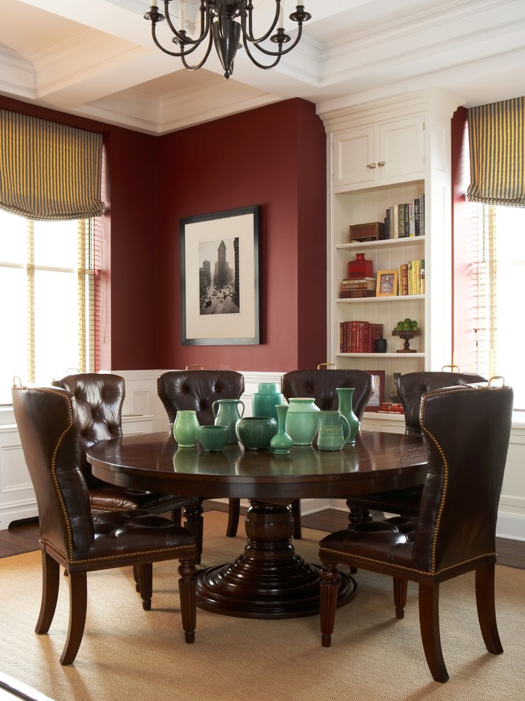 Design ideas for a traditional dining room in New York with red walls and dark hardwood floors.