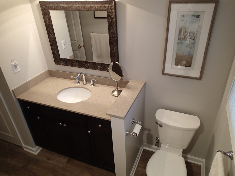 Mid-sized transitional bathroom in Philadelphia with an undermount sink, shaker cabinets, dark wood cabinets, engineered quartz benchtops, an alcove tub, a two-piece toilet, gray tile, porcelain tile, grey walls and vinyl floors.