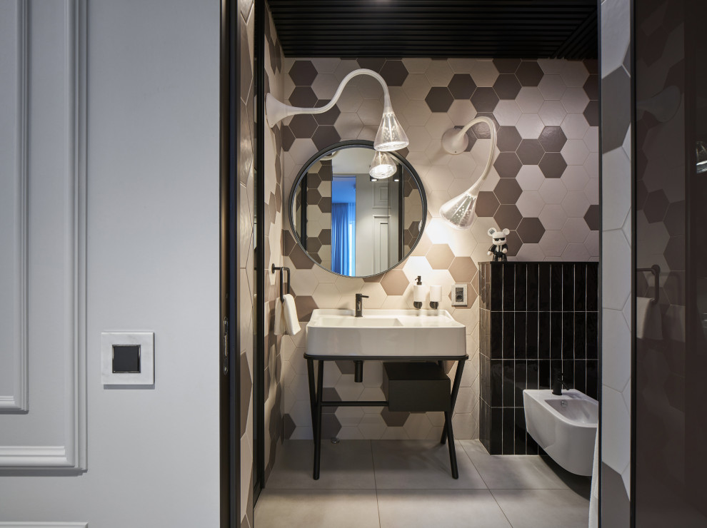 Photo of a mid-sized contemporary kids bathroom in Yekaterinburg with flat-panel cabinets, a wall-mount toilet, multi-coloured tile, ceramic tile, ceramic floors, a pedestal sink, a freestanding vanity, wood, panelled walls, black cabinets, an alcove tub, a shower/bathtub combo, multi-coloured walls, tile benchtops, grey floor, a sliding shower screen, black benchtops and a single vanity.