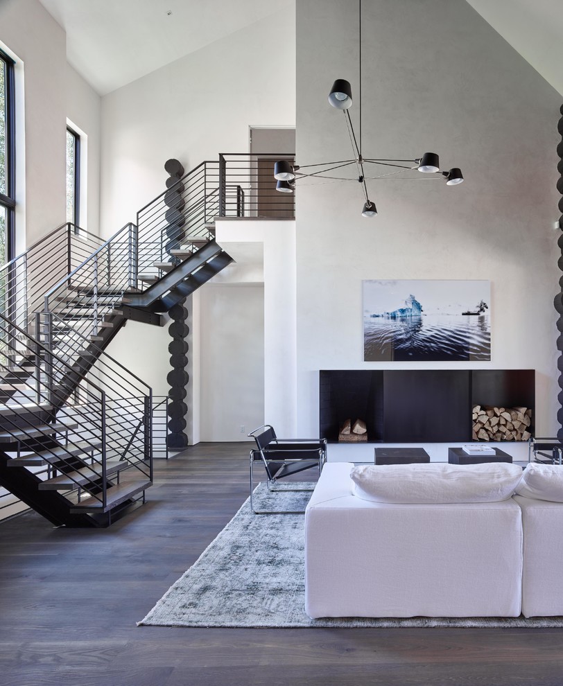 This is an example of a large contemporary wood floating staircase in Other with open risers and metal railing.