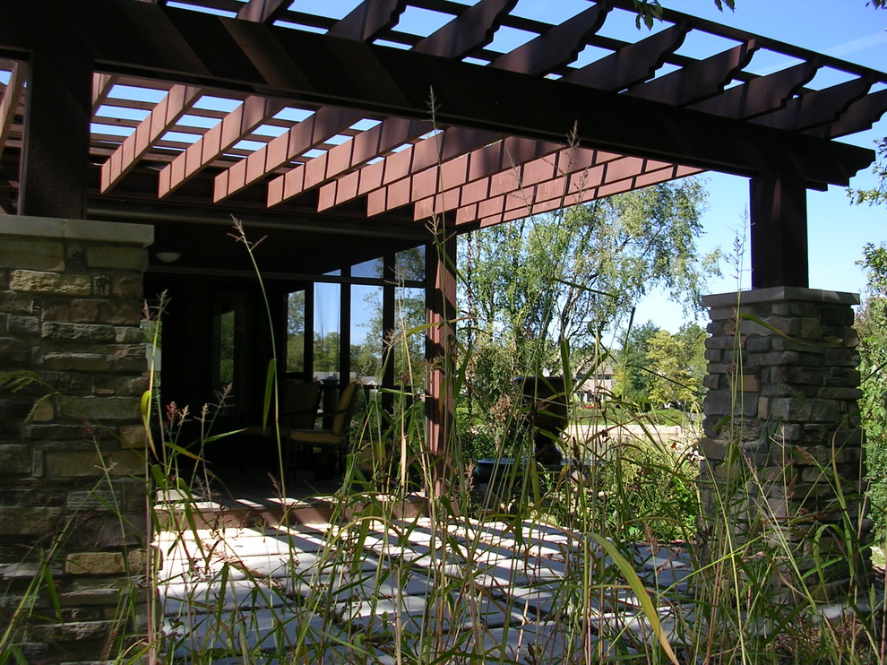 Example of a small mountain style backyard concrete patio design with a pergola