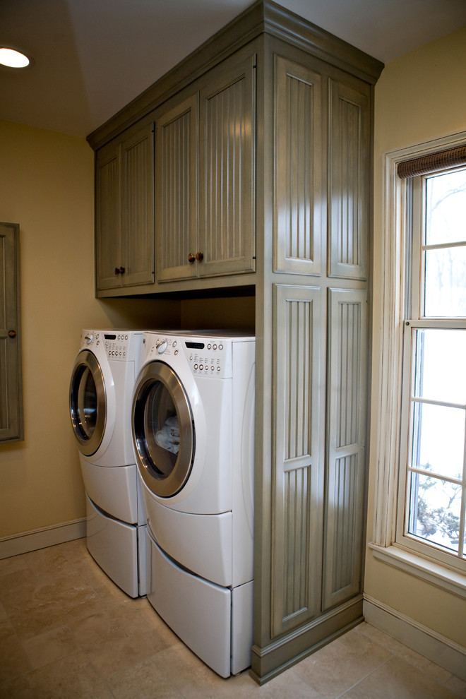 Photo of a country laundry room in Chicago with green cabinets, a side-by-side washer and dryer and recessed-panel cabinets.