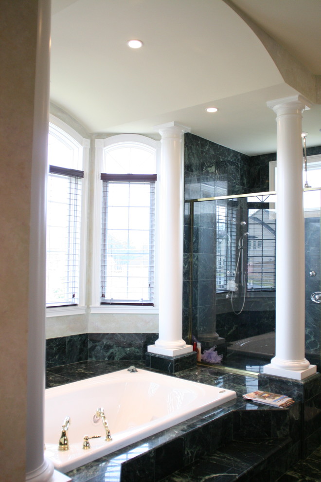 Large traditional master bathroom in New York with a drop-in tub, a corner shower, green tile, white walls, marble, marble floors, green floor and a hinged shower door.