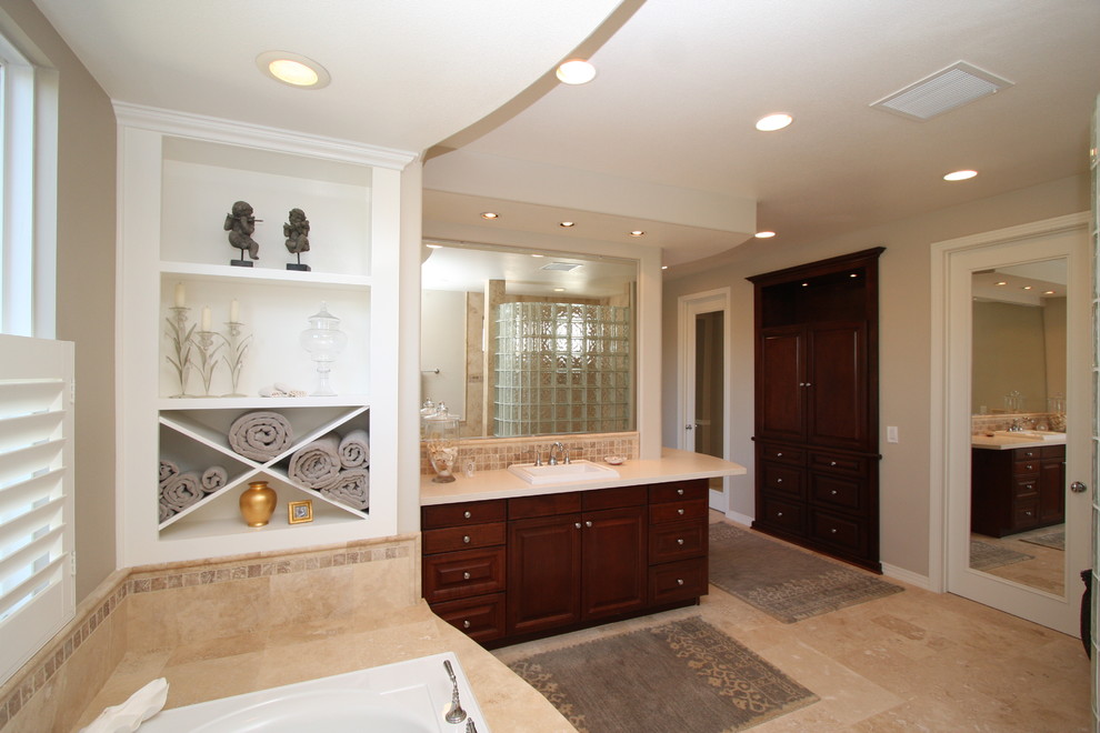 Large traditional master bathroom in Orange County with a drop-in sink, open cabinets, white cabinets, granite benchtops, a drop-in tub, a shower/bathtub combo, a two-piece toilet, multi-coloured tile, porcelain tile, beige walls and porcelain floors.