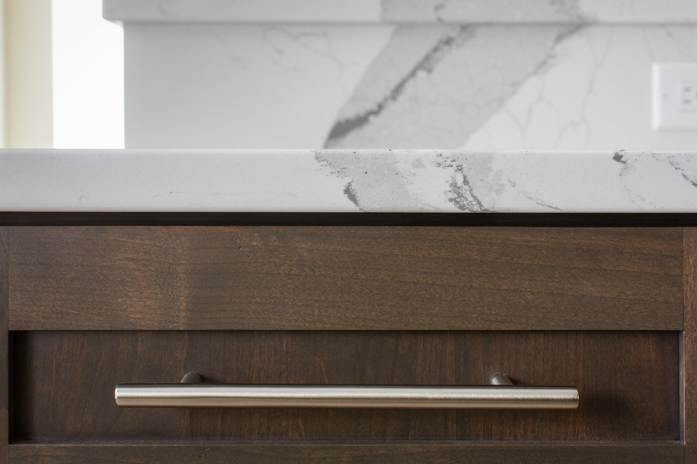Example of a huge transitional l-shaped light wood floor and brown floor home design design in Denver with an undermount sink, shaker cabinets, medium tone wood cabinets, quartz countertops, white backsplash, subway tile backsplash, stainless steel appliances, two islands and multicolored countertops