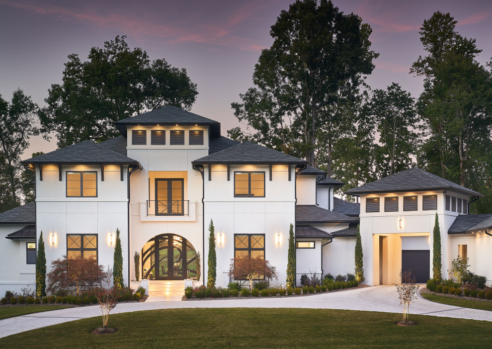 Inspiration for a large contemporary white house exterior in Charlotte with a grey roof.