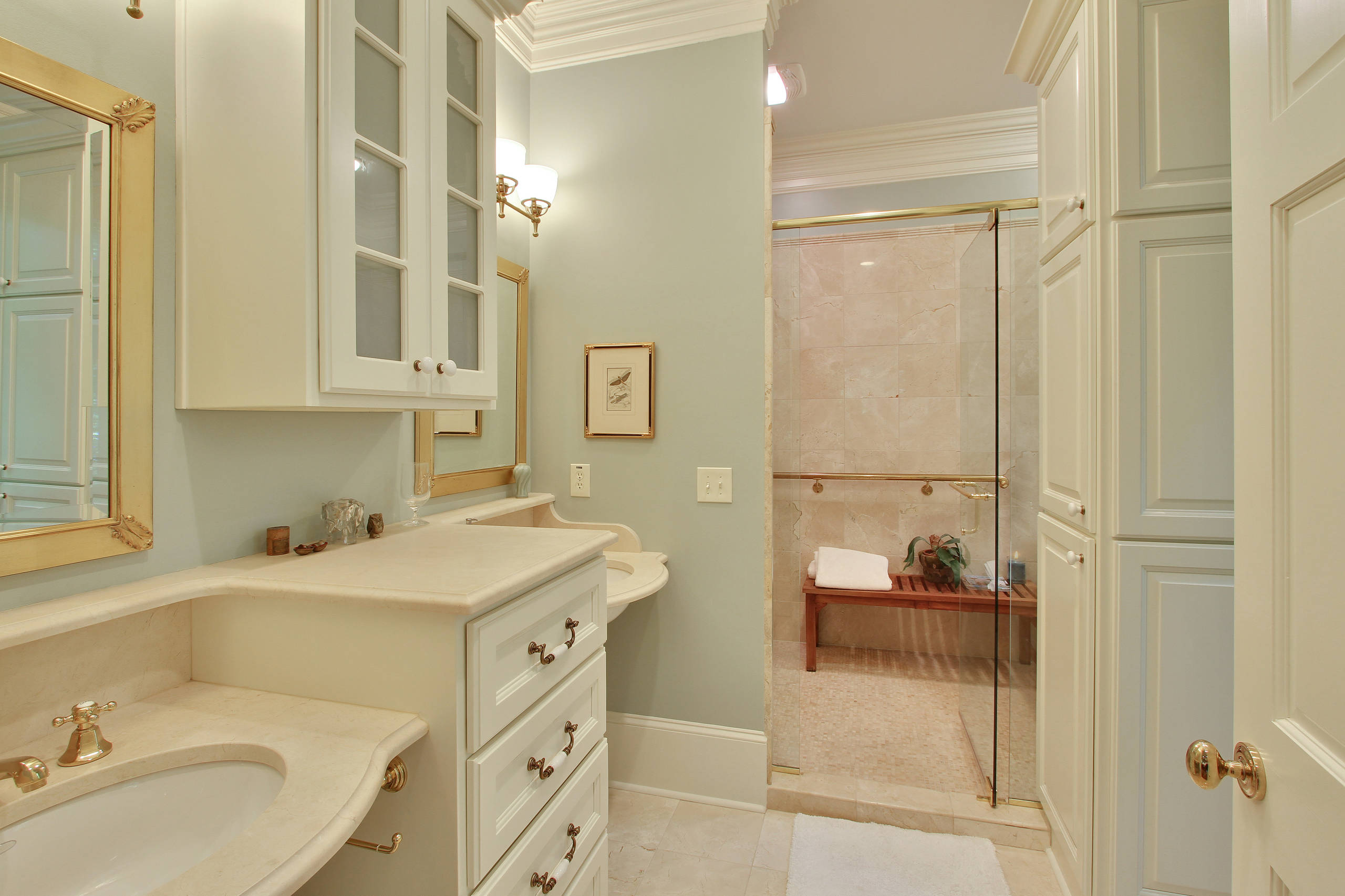 I don't believe in large wasted space to heat/cool/clean, so I designed this master bath with lots of hidden storage and re-created old style wall hung honed marble sinks from the 30's.  The shower ar