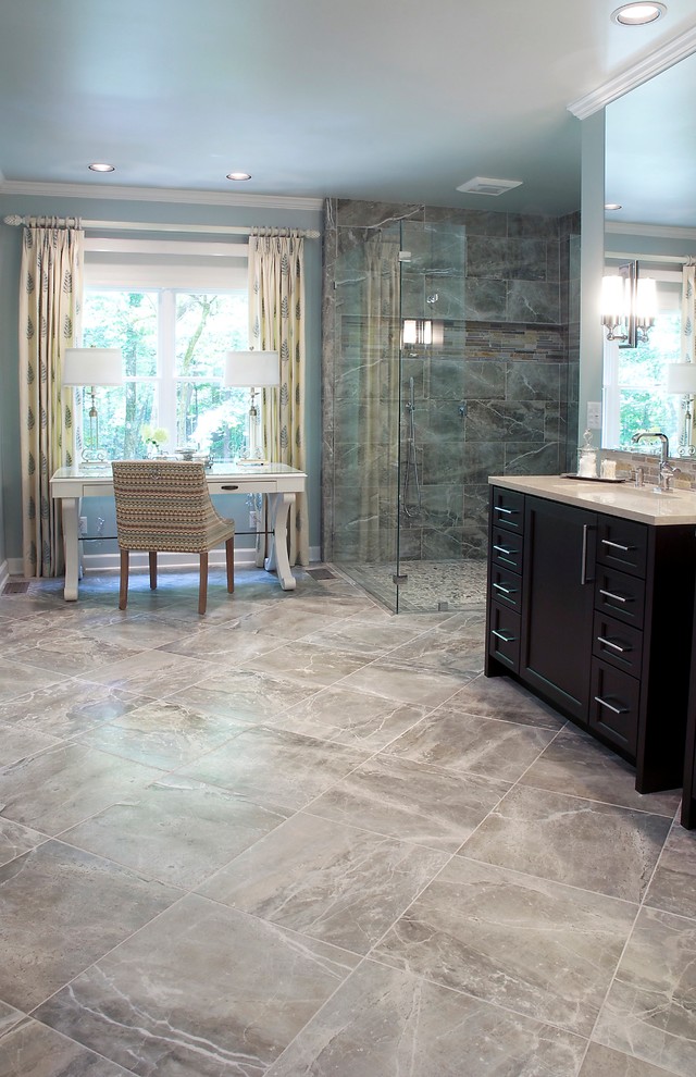 Design ideas for an expansive transitional master bathroom in DC Metro with a corner shower, gray tile, porcelain tile, porcelain floors, shaker cabinets, black cabinets, blue walls, an undermount sink and solid surface benchtops.