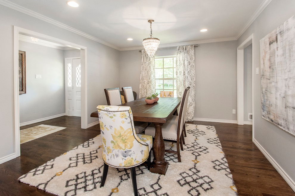 This is an example of a mid-sized transitional open plan dining in Dallas with grey walls, medium hardwood floors, a standard fireplace and a brick fireplace surround.