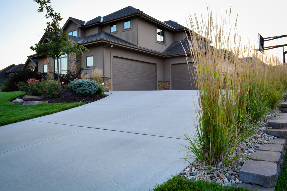 Inspiration for a mid-sized country front yard partial sun garden in Omaha with concrete pavers.