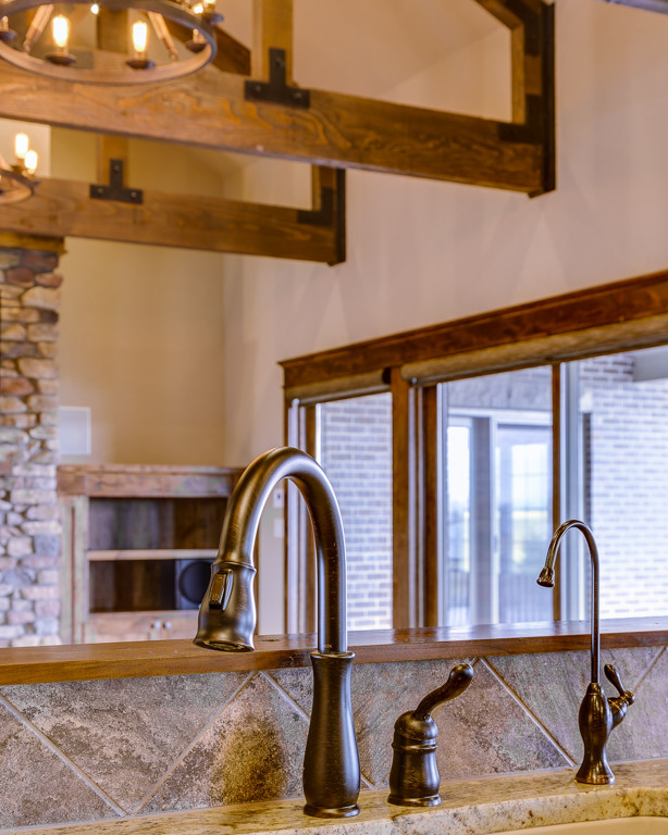 Inspiration for a rustic u-shaped eat-in kitchen remodel with an undermount sink, shaker cabinets and an island