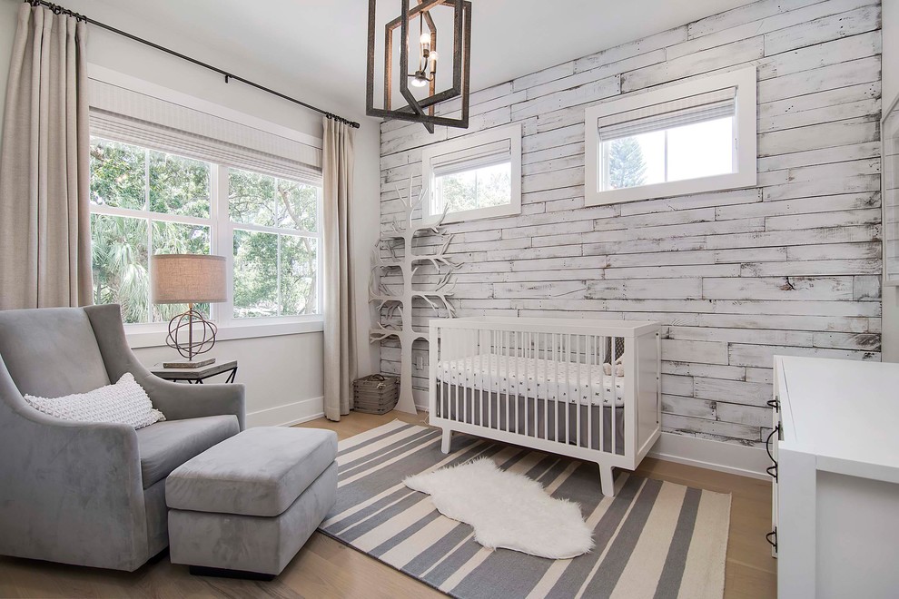 Design ideas for a large beach style gender-neutral nursery in Orlando with light hardwood floors, white walls and beige floor.